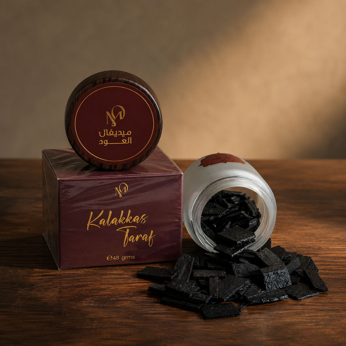Kalkas Taraf scented oud 48g — loose flat-cut oud chips beside a frosted jar and a printed Medieval Aloud box