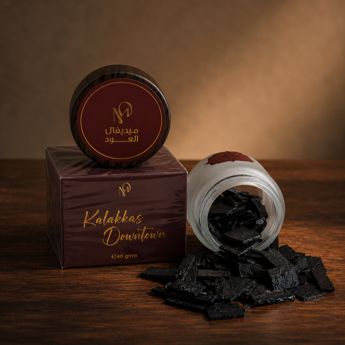 Kalakas Downtown scented oud 48g — loose flat-cut oud chips beside a frosted jar and a printed Medieval Aloud box