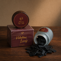 Kalkas Lounge scented oud 48g — loose flat-cut oud chips beside a frosted jar and a printed Medieval Aloud box